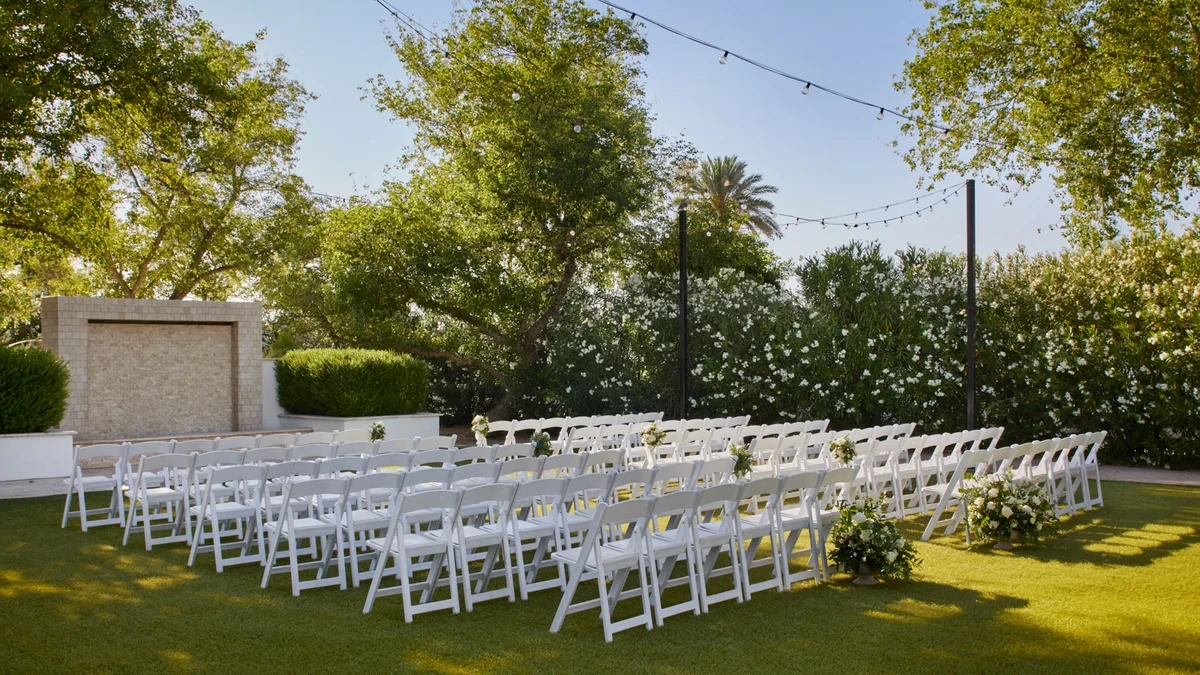 Lindsay Grove outdoor ceremony venue with white chairs on a lawn